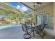 A covered patio with a table and chairs overlooks a screened in pool at 18631 Le Dauphine Pl, Lutz, FL 33558