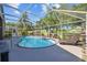Inviting screened pool area with relaxing lounge chair and serene backyard view at 18631 Le Dauphine Pl, Lutz, FL 33558