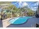 Sparkling screened in swimming pool surrounded by lush landscaping, perfect for entertaining at 18631 Le Dauphine Pl, Lutz, FL 33558