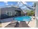 Private backyard pool with lounge chairs surrounded by a screened enclosure at 18631 Le Dauphine Pl, Lutz, FL 33558