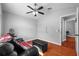 Comfortable sitting area with hardwood floors, leather couch, and an ottoman at 18631 Le Dauphine Pl, Lutz, FL 33558