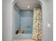 Blue tiled bathroom with a bathtub and leaf-patterned shower curtain, creating a serene and stylish space at 2003 Cordova Grn, Seminole, FL 33777