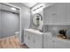 Stylish bathroom featuring a double sink vanity, modern lighting, decorative mirror, and plenty of cabinet space at 2003 Cordova Grn, Seminole, FL 33777