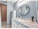 Bathroom features a shower, marble countertop, modern vanity, and ample storage creating a clean and organized space at 2003 Cordova Grn, Seminole, FL 33777