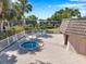 A hot tub inside a fenced area, featuring a lounge area with blue chairs at 2003 Cordova Grn, Seminole, FL 33777