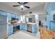 Bright updated kitchen with stainless appliances, blue cabinetry, butcher block counters, and an open view to the dining area at 2003 Cordova Grn, Seminole, FL 33777