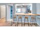 Open kitchen with breakfast bar, modern stools, and great natural light at 2003 Cordova Grn, Seminole, FL 33777