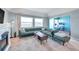 Inviting living room with a fireplace, large windows, and modern furniture at 2003 Cordova Grn, Seminole, FL 33777