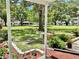 Relaxing back patio with views of a lush green lawn and mature trees at 2293 Swedish Dr # 11, Clearwater, FL 33763