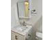 Bathroom featuring a white vanity with a marble countertop, a mirror, and a toilet at 2293 Swedish Dr # 11, Clearwater, FL 33763