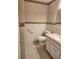 Bathroom features cream tile, wallpapered accent wall, and large vanity at 2293 Swedish Dr # 11, Clearwater, FL 33763
