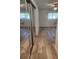 Bedroom with wood-look flooring, ceiling fan and mirrored closet at 2293 Swedish Dr # 11, Clearwater, FL 33763