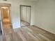 Bedroom featuring hard surface floors and mirrored closet doors at 2293 Swedish Dr # 11, Clearwater, FL 33763
