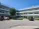 Multi-level condo complex featuring multiple balconies with white railings and neatly maintained landscaping at 2293 Swedish Dr # 11, Clearwater, FL 33763