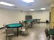 A game room featuring poker tables and chairs with bright lighting and ample space at 2293 Swedish Dr # 11, Clearwater, FL 33763