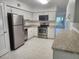 Kitchen featuring stainless steel appliances, white cabinets and a countertop at 2293 Swedish Dr # 11, Clearwater, FL 33763