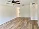 Living room featuring modern flooring, ceiling fan and neutral paint leading to kitchen at 2293 Swedish Dr # 11, Clearwater, FL 33763