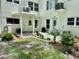 Rear of the building showing a patio and well-maintained landscaping at 2293 Swedish Dr # 11, Clearwater, FL 33763