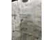 Updated shower featuring marble-look tile, handheld sprayer, and grab bars for accessibility and safety at 2293 Swedish Dr # 11, Clearwater, FL 33763