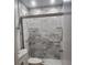 Shower featuring marble-like tile and grab bars at 2293 Swedish Dr # 11, Clearwater, FL 33763