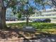 Property signage surrounded by mature trees and lawn at 2293 Swedish Dr # 11, Clearwater, FL 33763