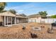Relaxing backyard setting with a screened porch, laundry facilities, fire pit, grill, and secure fencing at 2916 W Crest Ave, Tampa, FL 33614