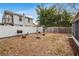 Backyard with a fire pit, grill, shed, white fence, providing a private outdoor space at 2916 W Crest Ave, Tampa, FL 33614