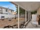 Covered patio overlooking the backyard, featuring a grill, fire pit and white vinyl fencing at 2916 W Crest Ave, Tampa, FL 33614
