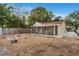 Backyard view features a screened porch with laundry hookups, a firepit, and ample room for outdoor activities at 2916 W Crest Ave, Tampa, FL 33614