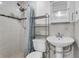Bright bathroom with a tiled shower, matching tiled walls, and a pedestal sink at 2916 W Crest Ave, Tampa, FL 33614