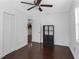 Bedroom features hardwood floors, a ceiling fan, closet, and a shelving unit at 2916 W Crest Ave, Tampa, FL 33614