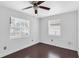 Bedroom with hardwood floors, two windows, and white walls at 2916 W Crest Ave, Tampa, FL 33614