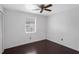 Bedoom featuring hardwood floors, a ceiling fan and a window at 2916 W Crest Ave, Tampa, FL 33614