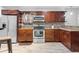 Contemporary kitchen with stainless appliances, granite counters, tile backsplash, and breakfast bar at 2916 W Crest Ave, Tampa, FL 33614