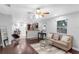 Open-concept living space with hardwood floors and seamless flow into the kitchen and dining area at 2916 W Crest Ave, Tampa, FL 33614