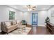 Cozy living room featuring a modern ceiling fan, ample seating, and a stylish area rug at 2916 W Crest Ave, Tampa, FL 33614