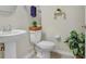 Powder room featuring a pedestal sink, and a decorative shelf adding charm to the space at 29901 Southwell Ln, Wesley Chapel, FL 33543
