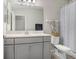 Bright bathroom featuring a single sink vanity, a big mirror, a toilet, and a shower curtain at 29901 Southwell Ln, Wesley Chapel, FL 33543