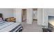 Bedroom with view of doorway, bathroom, neutral walls, large carpeted floor, and a comfortable bed at 29901 Southwell Ln, Wesley Chapel, FL 33543