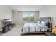 Bright bedroom featuring carpet, neutral walls, ample natural light through windows, and modern furnishings at 29901 Southwell Ln, Wesley Chapel, FL 33543