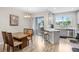 Dining area with an adjacent kitchen, hardwood floors, and sliding door access to outdoor area at 29901 Southwell Ln, Wesley Chapel, FL 33543