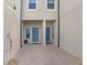 Between homes showcasing dual front doors, small garden, and paver flooring, providing an intimate entrance at 29901 Southwell Ln, Wesley Chapel, FL 33543