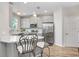 Kitchen featuring stainless steel appliances, white countertops, island seating, and easy access to a door at 29901 Southwell Ln, Wesley Chapel, FL 33543