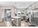 Well-lit kitchen featuring stainless steel appliances, white cabinets, a peninsula, and a sliding glass door at 29901 Southwell Ln, Wesley Chapel, FL 33543