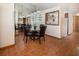 Dining area with a glass table, leather chairs, and a mirrored accent wall at 3010 Beecher E Dr # A, Palm Harbor, FL 34683