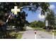 Scenic view of the Dunedin entrance sign over a paved path surrounded by lush greenery and trees at 3010 Beecher E Dr # A, Palm Harbor, FL 34683