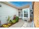 Charming entryway with lush landscaping, a bench, and a well-maintained walkway at 3010 Beecher E Dr # A, Palm Harbor, FL 34683