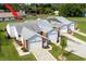 Aerial view of townhomes with gray roof and well maintained lawn at 3010 Beecher E Dr # A, Palm Harbor, FL 34683