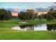 Picturesque golf course view with a pond reflecting the sky, green fairways, and mature trees at 3010 Beecher E Dr # A, Palm Harbor, FL 34683