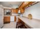 Bright kitchen features tile flooring, white appliances, and solid countertops at 3010 Beecher E Dr # A, Palm Harbor, FL 34683